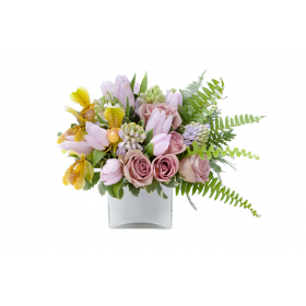 Flower arrangement in a low, white, ceramic vase, lavender tulips, lavender hyacinths, lavender roses, yellow lady's slipper orchids