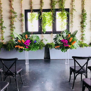 Wedding ceremony decor with 2 tall tropical arrangement with fuschia and orange flowers on glass stands