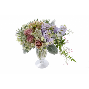 Flower arrangement in a low, tulipe shape, clear glass vase, antique hydrangeas, lavender hyacinths, pink roses, green thistle, white astrantias and jasmine vines