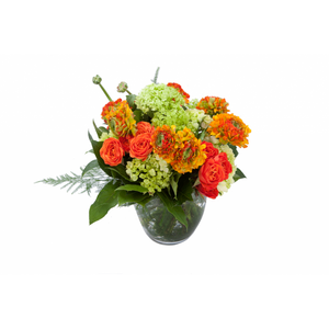 Flower arrangement in a low, round, clear glass vase, green hydrangeas, green viburnum, orange spray roses and orange ranunculus
