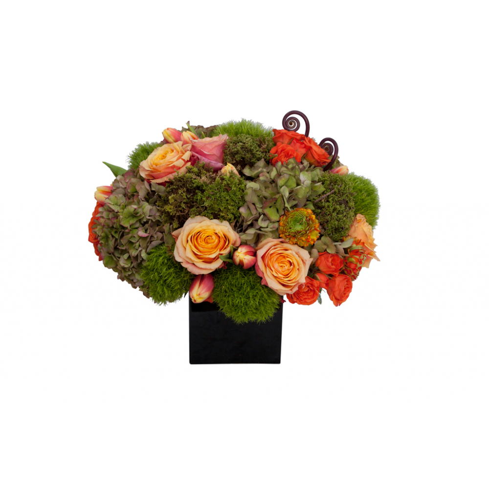 Flower arrangement in a low, square, black, ceramic vase, antique green hydrangea, orange roses, orange spray roses, orange ranunculus and green dianthus