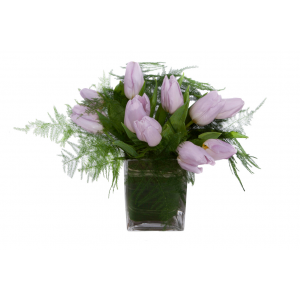 Flower arrangement in a low, square, clear glass vase, lavender tulips and asparagus ferns